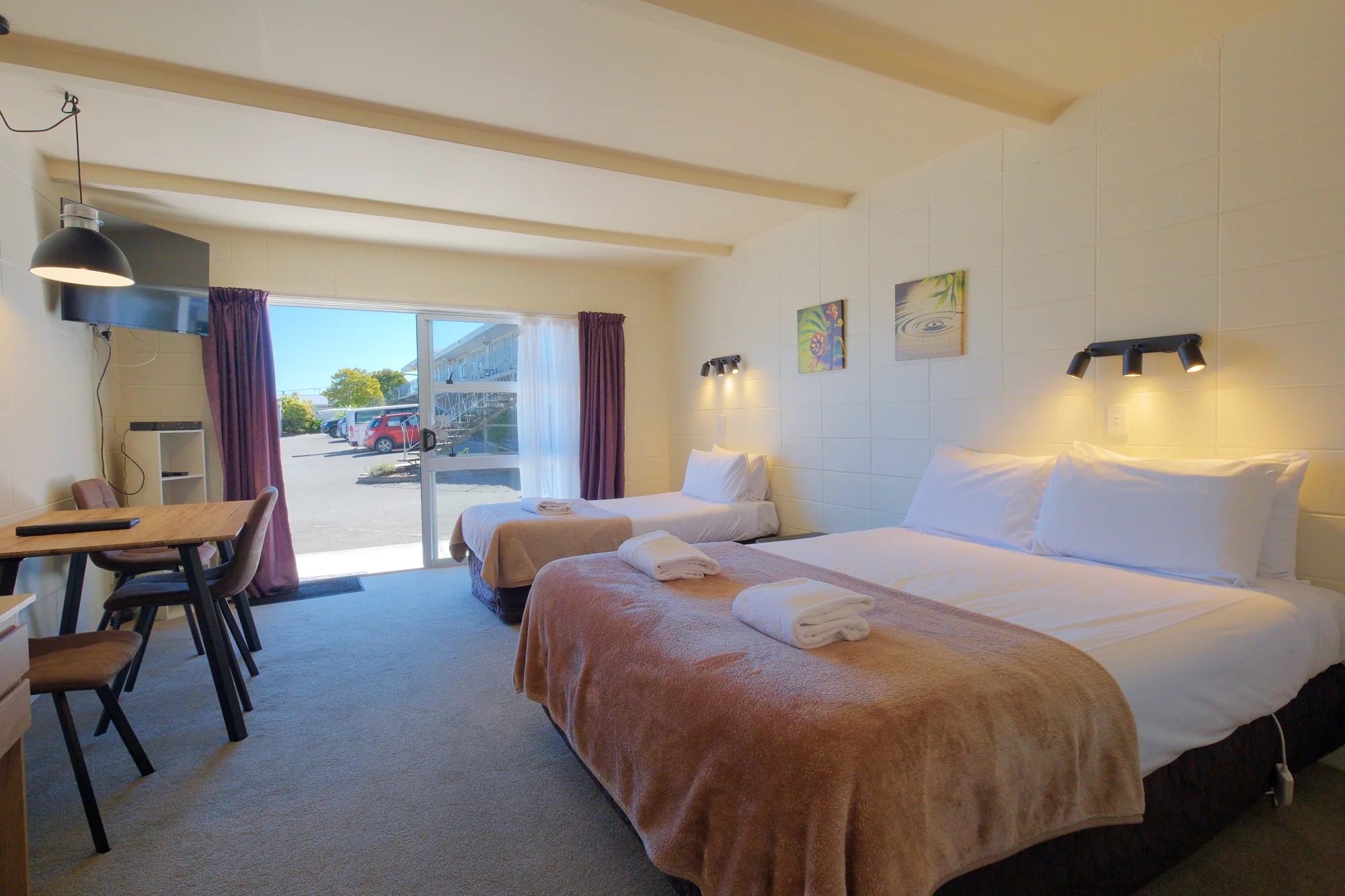 Bedroom and dining space at Twin Peaks Lakeside Inn, Taupō